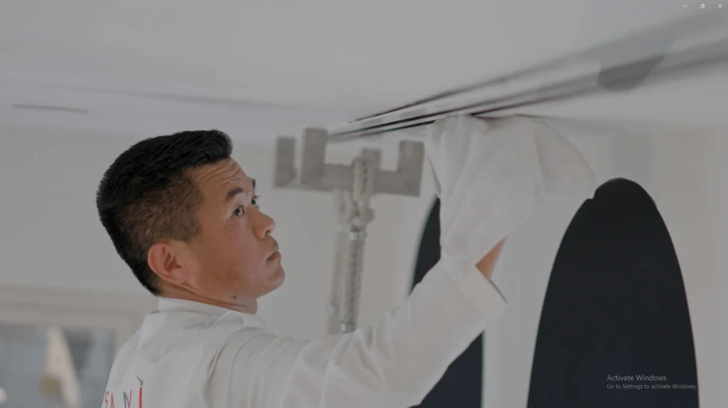 Guy wearing white inspecting a AC duct