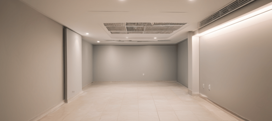 AC Duct Cleaning for High-Rise Apartments Ajman - NADCA-certified technician inspecting duct grille in residential tower